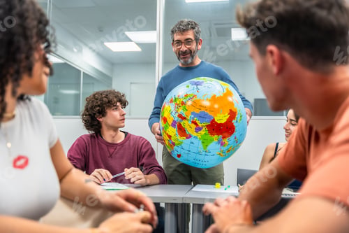 Preview: Professor teaching geography with a globe to students
