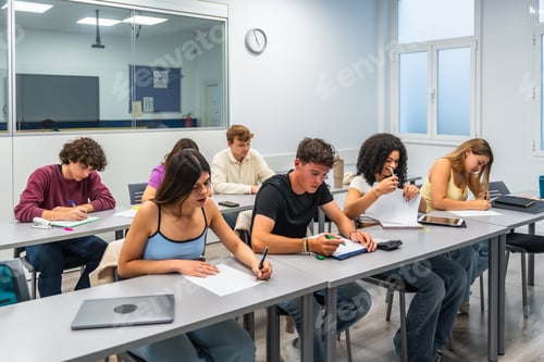 Preview: Young students concentrating on notes during an exam or test