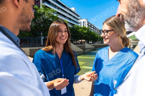 Preview: Healthcare professionals discussing outdoors, sharing expertise and teamwork