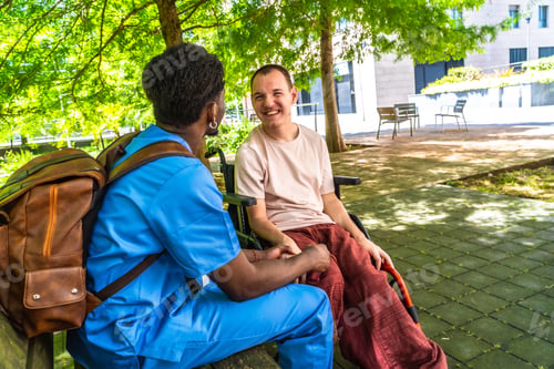 Preview: Caregiver and patient smiling together outdoors