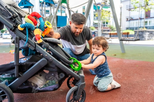 Preview: Father and son playing with stroller in park