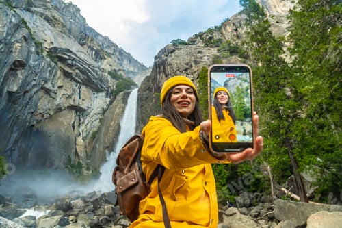 Preview: Woman enjoying yosemite falls making a travel selfie video