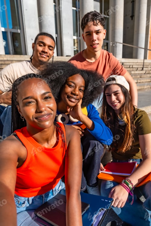 Preview: Diverse students taking selfie on university campus stairs