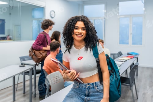 Preview: Smiling young woman student standing in classroom