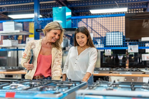 Preview: Mother and daughter shopping for gas stove at home improvement store
