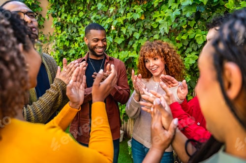 Preview: Diverse group applauding success during support meeting