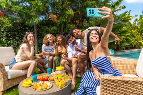 Preview: Diverse friends enjoying summer outdoor party taking selfie