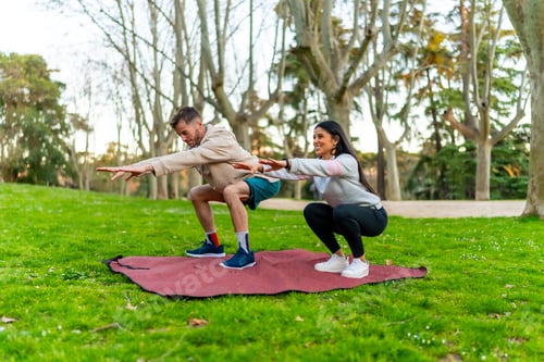 Preview: Couple exercising outdoors doing squats on mat