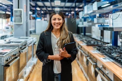 Preview: Woman smiling holding tablet in home improvement store