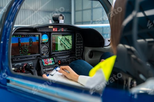Preview: Pilot checking aircraft before flight in hangar