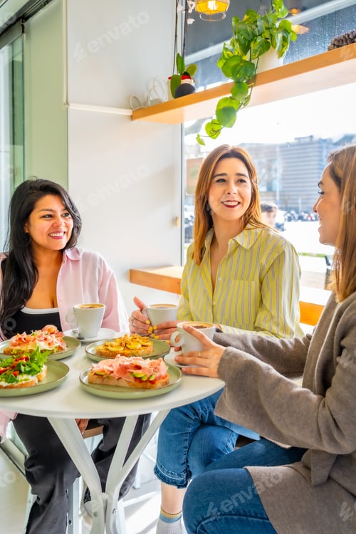 Preview: Women enjoying brunch and coffee together at a cafe