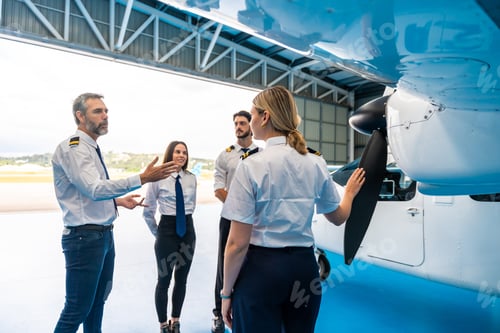 Preview: Aviation instructor teaching student pilots about airplane engine