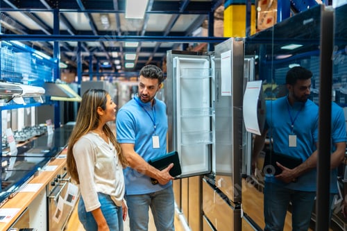 Preview: Salesperson assisting customer choosing new home appliance