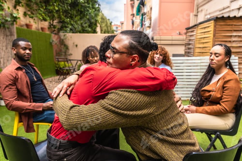 Preview: People hugging during a group therapy session outdoors
