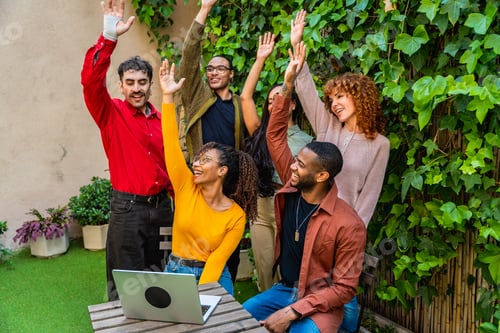 Preview: Diverse group of young people celebrating success in an outdoor setting