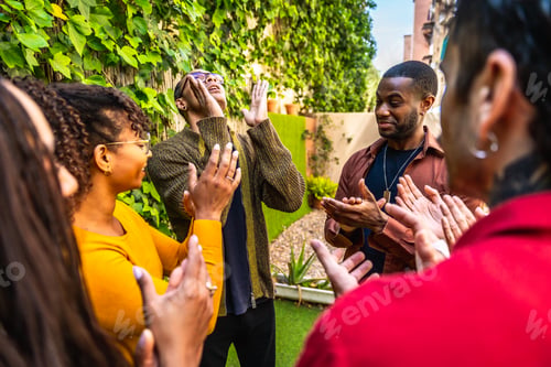 Preview: Diverse people clapping and supporting during outdoor group therapy session