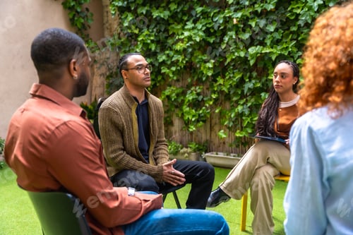 Preview: Diverse people participating in outdoor group therapy counseling session