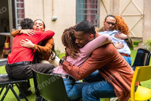 Preview: Diverse people hugging during group therapy support session