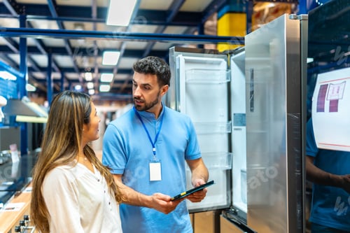 Preview: Salesperson advising woman on new refrigerator purchase