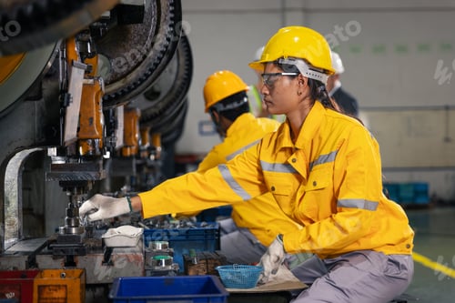Preview: Female Factory Worker Operating Industrial Press Machine in Modern Manufacturing Production Line