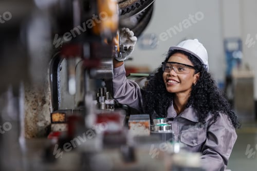 Preview: Female Manufacturing Technician Inspecting Industrial Press Machine During Preventive Maintenance