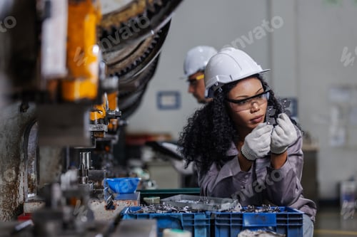Preview: Female Manufacturing Technician Inspecting Precision Metal Component for Quality Control in Factory