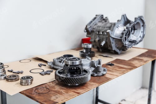 Preview: Disassembled Electric Vehicle Drive Unit Components on Workbench for Inspection and Repair