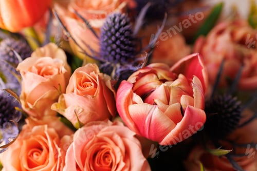 Preview: Bright flowers in a floral arrangement on a table with a simple background during daylight hours in