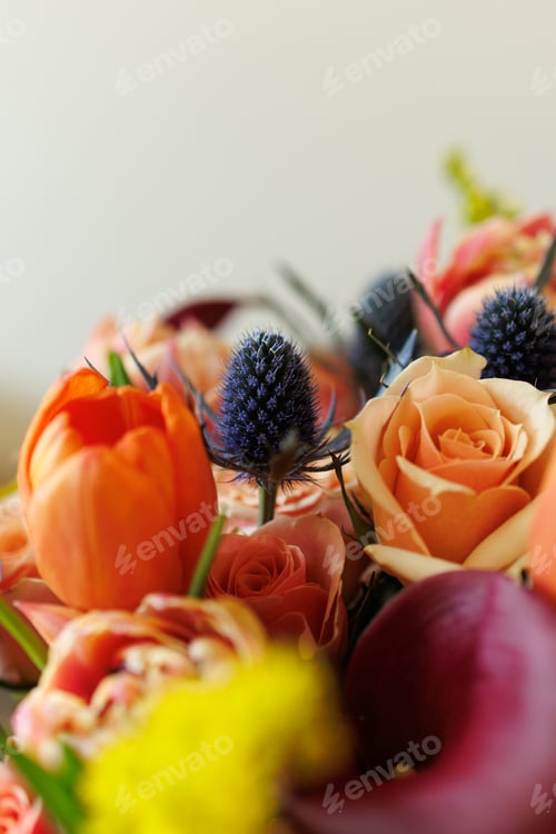 Preview: Colorful flowers arranged in a bouquet with roses, tulips, and other blooms placed on a light backgr