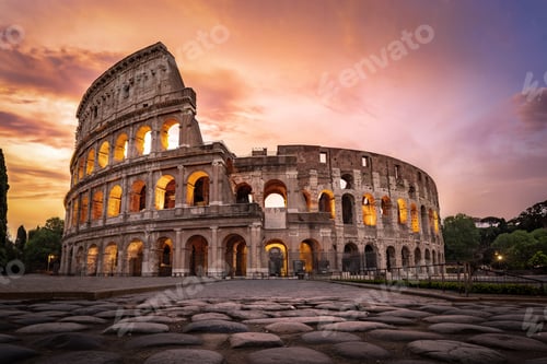 Preview: The Colosseum illuminated under a fiery sunset sky with ancient basalt pavement.