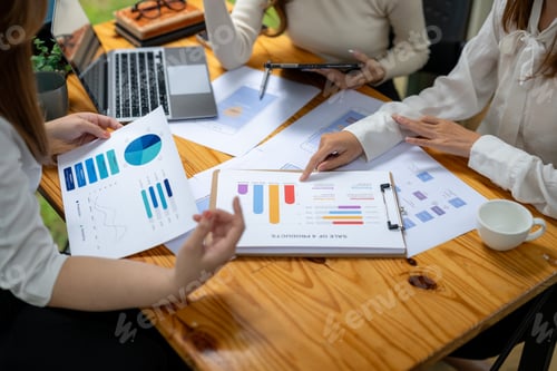 Preview: Collaborative Business Meeting with Charts and Graphs on Table