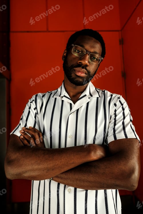 Preview: Black man posing confidently with arms crossed