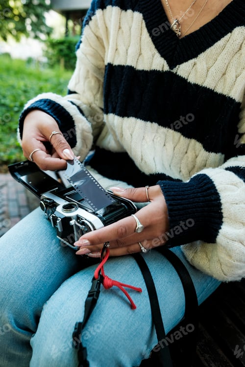 Preview: Person loading analog film into vintage camera