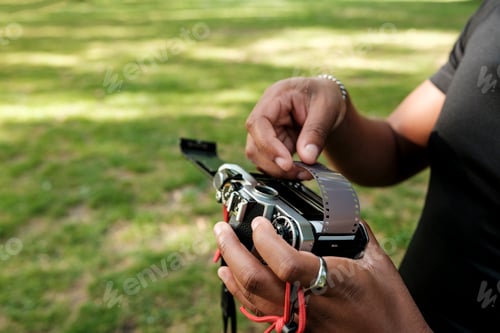 Preview: Person loading 35mm film into vintage analog camera