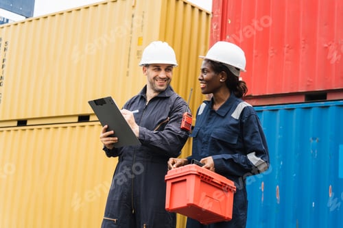 Preview: Diverse team of logistics collaborating with clipboard, toolbox while checking cargo container inven