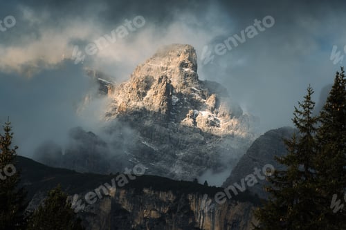 Preview: Dramatic Dolomites mountain with storm clouds and sunlight shines in Italy