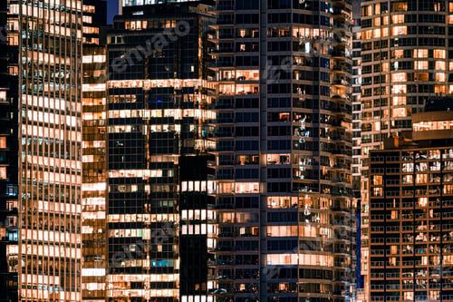 Preview: Facade windows of illuminated modern skyscraper with office building