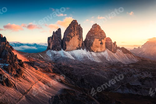 Preview: Sunset over Tre Cime di Lavaredo surrounded by alpine terrain in Dolomites, Italy