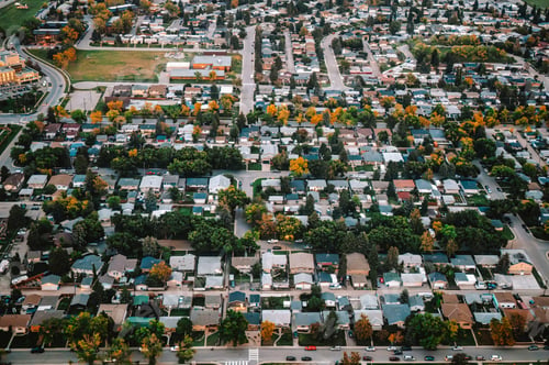 Preview: Aerial view of suburban neighborhood with tree lined street in autumn