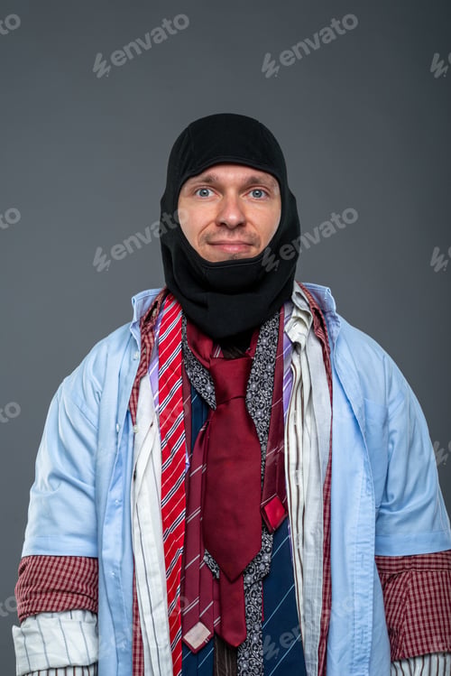 Preview: A man in a black balaclava wiping sweat from his brow