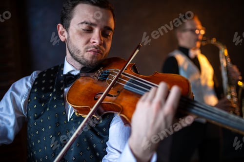 Preview: Close up of a violinist playing with a saxophonist out of focus