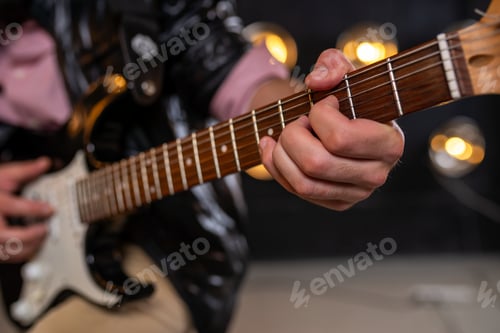 Preview: Close up of fingers on electric guitar fretboard