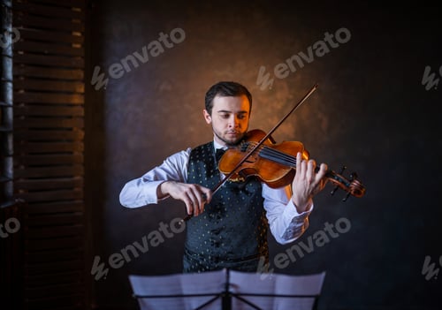 Preview: Male violinist playing instrument behind music stand