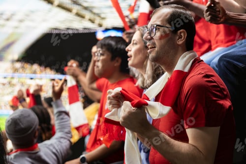 Preview: Anxious football supporters watching a decisive final attack during match