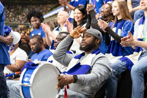 Preview: Passionate supporter playing fan drums and starting a stadium chant