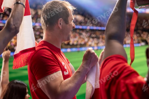 Preview: Close up of happy soccer supporter doing ovations in packed stadium