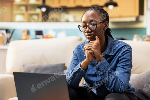 Preview: Black woman cracking her knuckles due to a nervous habit at home