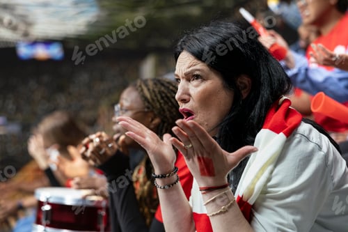 Preview: Emotional mature female football fan reacting with open hands in disbelief