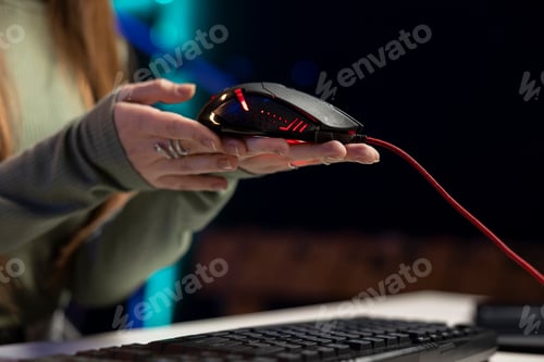 Preview: Girl content creator presenting gaming mouse review video at home