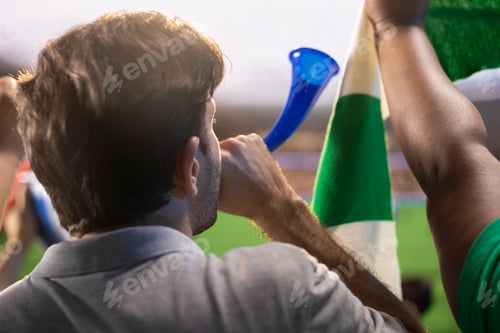 Preview: Close up of man in football stadium blowing air horn